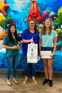 Alexis Carreon and Kelley Ashley present an Apple IPad to Audrey Rhodes, the Grand Prize Winner of POC Library’s “Summer Reading Program”. Congratulations, Audrey!