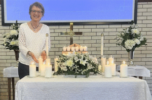   Tanya DeForest (at right) holds the candle that was lit in memory of her mother Lillian Stubbs at the “All Saints Sunday” memorial service at Seadrift’s United Methodist Church. This service on October 6th was held in memory of those who passed in 2022. Twenty-four people were honored with the lighting of a candle and the sound of a bell. What followed was scripture reading, silent meditation, and Holy Communion.  