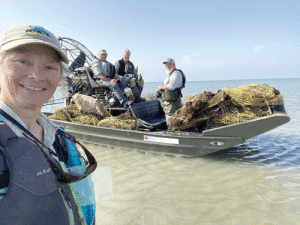 POC & Seadrift residents: Brigid & Allan Berger, Charles Gremminger, Chris Skeie with a boat load of traps removed from shallow back lakes of Matagorda Island. 