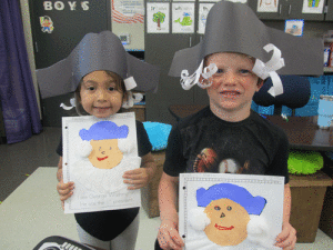 Penelope Gonzales and Reef Chance proudly display their George Washington artwork while looking like him.