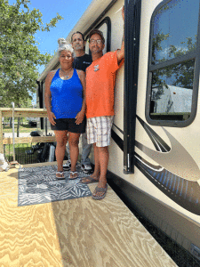 Tony and Marion Pool with Troy standing on the ramp that Troy, with the help of his grandson Ronnie Carriles, Jr. built for them. With the assistance of Judith at POC Hardware, funds were collected from several people to cover the cost of the materials.