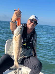 Tom Pope, caught a “bragging rights” keeper redfish at the Big Jetties on October 21.  A big live shrimp under a popping cork right up against the rocks proved too tempting for the redfish..