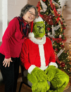 A very subdued Grinch with a Christmas party merrymaker. 