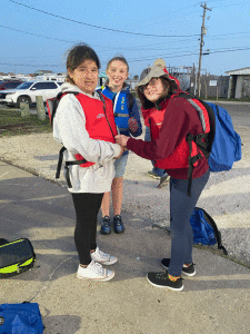 Anamika Brown helps Kylee Roman with her life jacket. Gilliana Gonzalez in background. All are 6th grade Seadrift School students. Ana is from Port O’Connor.