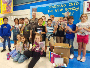 Seadrift School’s Principal, Mrs. Bermea and students from Mrs. Calloway’s Second Grade Class are pictured with some of the items donated by First Assembly of God, Seadrift. The church donated 140 pairs of earphones, 144 spiral notebooks, 216 pairs of scissors and 400 sets of earbuds.