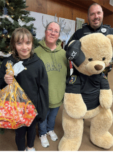 Looks who’s in this starring lineup at the Blue Santa giveaway at the Seadrift Nutcracker Market on December 7th! It’s Kassy with her mom, Beth Christy, Buddy the Bear, and Seadrift PD Patrolman James Easley, Jr.   Kassy is holding a bag of Christmas gifts that were provided by generous donors in the community. Many thanks to Seadrift’s Police Department for hosting this wonderful event.	 -Tanya DeForest