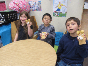 Adalynn McCabe, Alex Martinez, and Braysen Cardenas show off their edible bears in POC Kindergarten.