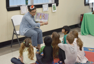 Beloved former Port O'Connor teacher, LeAnn Ragusin reads 10 Apples Up on Top to a group.