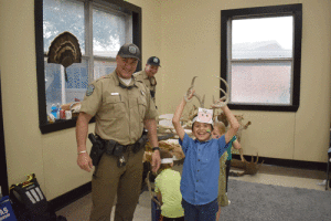 Osvin Guiterrez tries on some horns in the Game Warden station manned by Jared Lewis and Casey Whillmon.